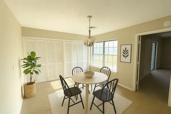 a dining room with furniture and window