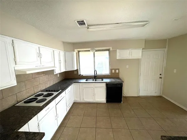 a large kitchen with a large window