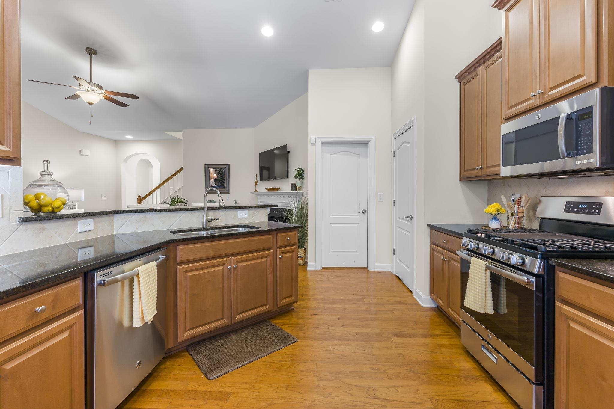 2015 Oxford Street Myrtle Beach, SC 29577 - Photo 12 of 40 Kitchen with appliances with stainless steel finishes, decorative backsplash, brown cabinetry, and recessed lighting