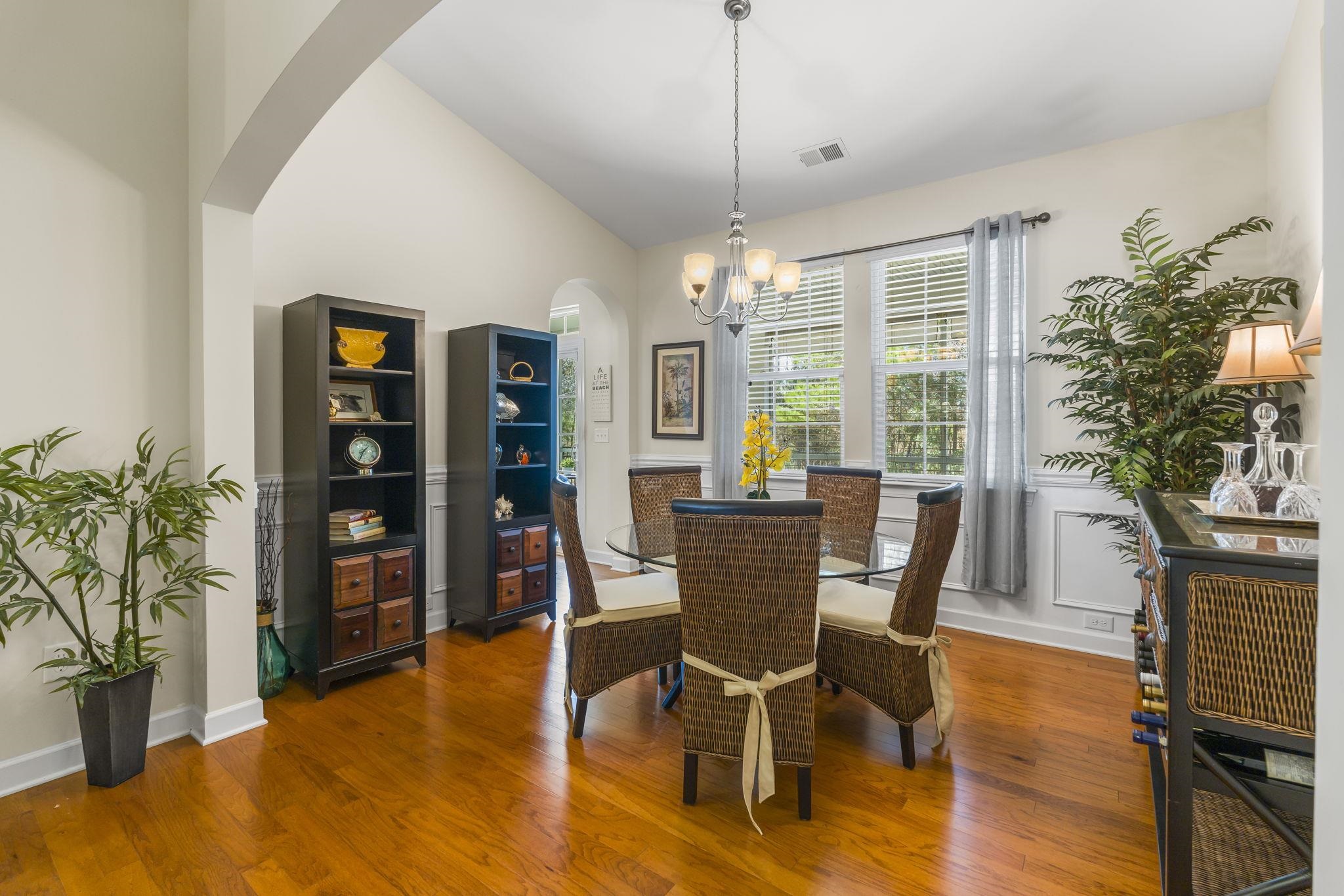 2015 Oxford Street Myrtle Beach, SC 29577 - Photo 15 of 40 Dining area with arched walkways, lofted ceiling, wood finished floors, and a chandelier