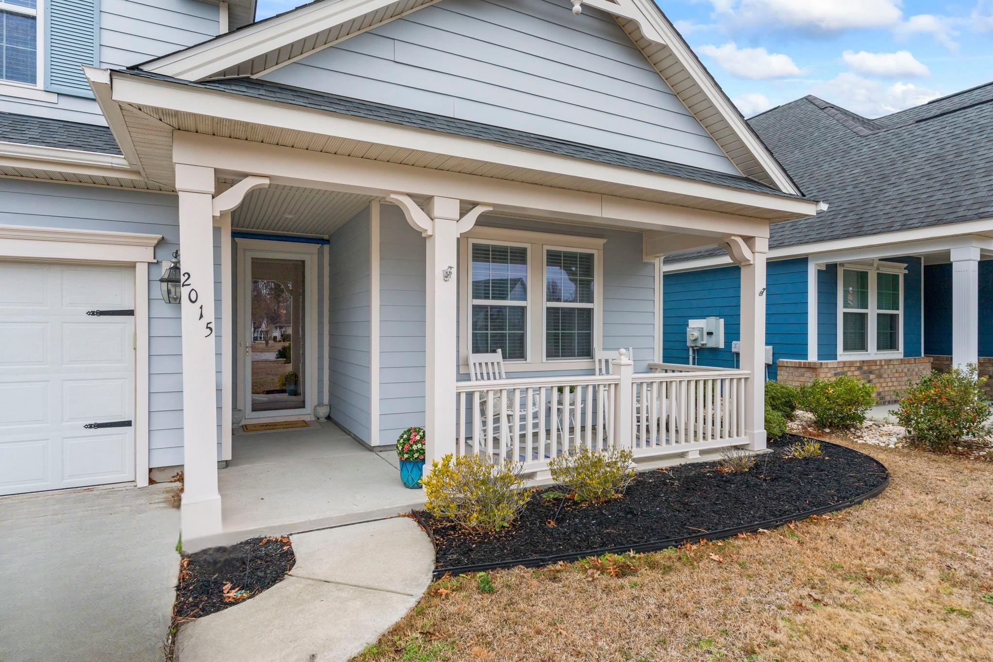 2015 Oxford Street Myrtle Beach, SC 29577 - Photo 2 of 40 View of exterior entry featuring a porch, a garage, and roof with shingles