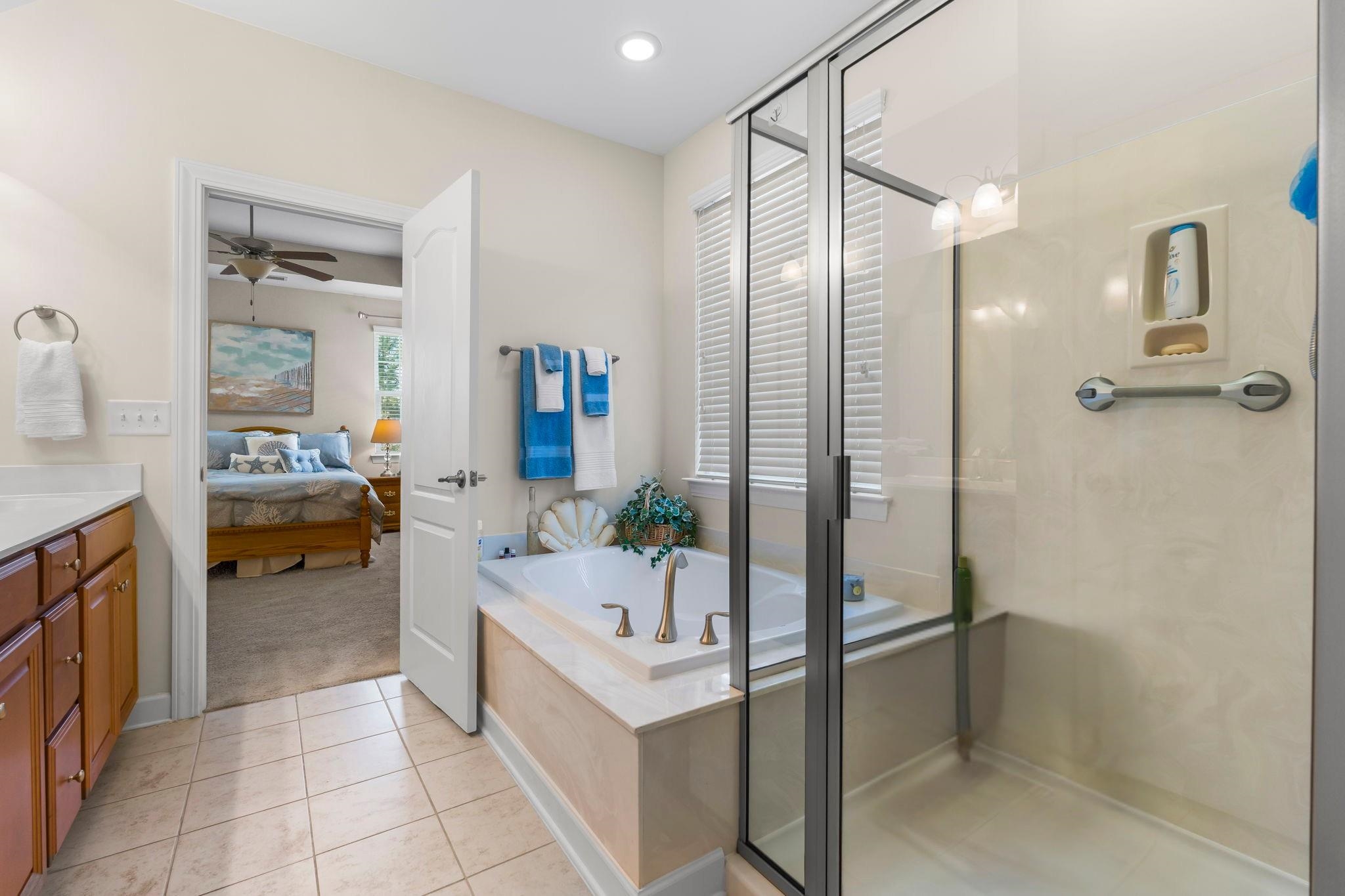 2015 Oxford Street Myrtle Beach, SC 29577 - Photo 21 of 40 Bathroom featuring vanity, a stall shower, a bath, connected bathroom, and light tile patterned floors