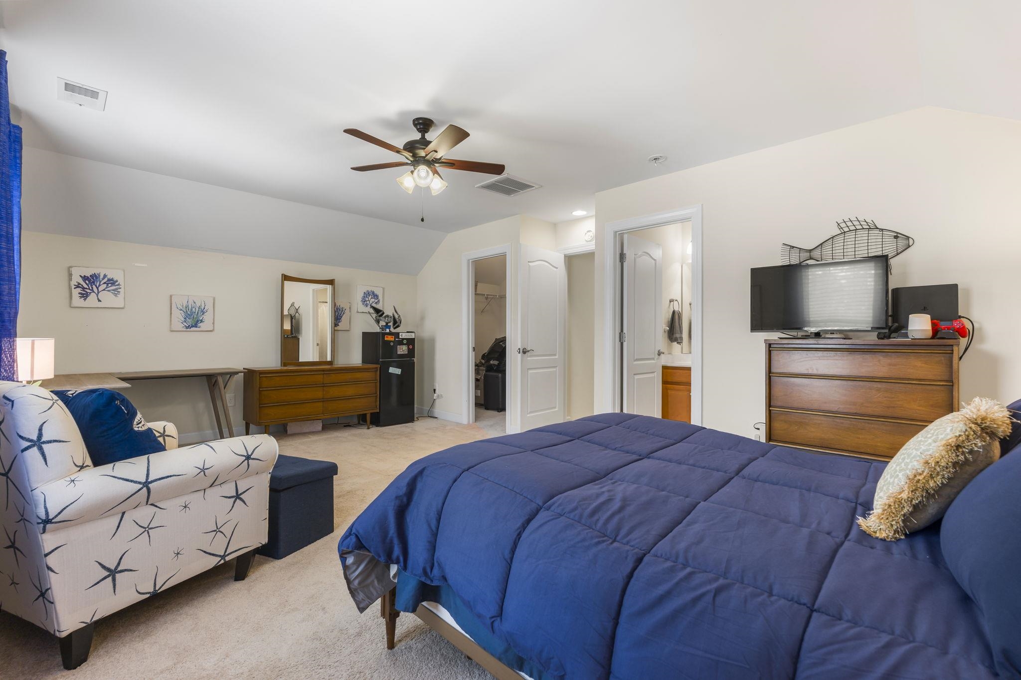 2015 Oxford Street Myrtle Beach, SC 29577 - Photo 27 of 40 Carpeted bedroom with a spacious closet, vaulted ceiling, ceiling fan, and connected bathroom