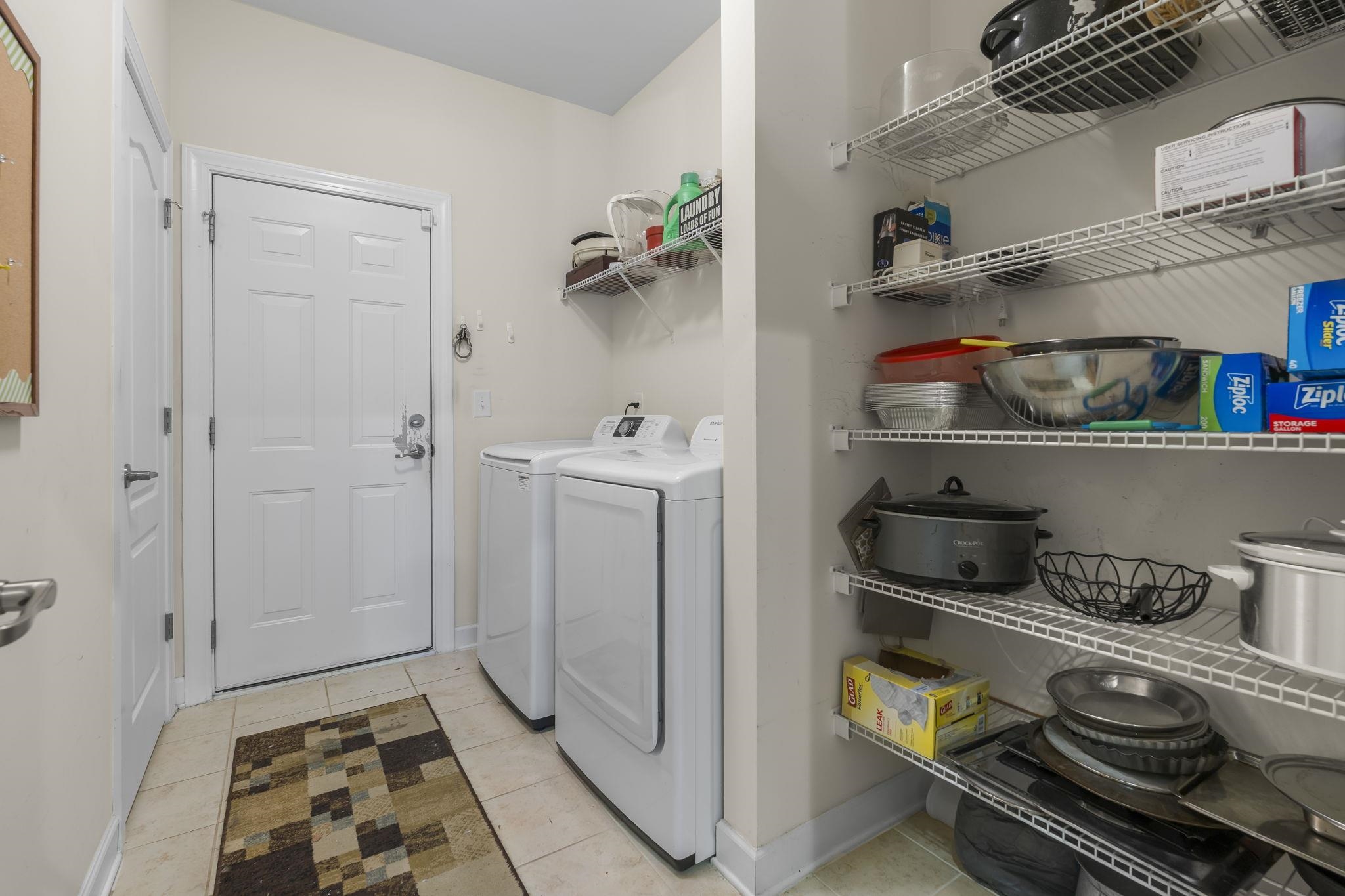 2015 Oxford Street Myrtle Beach, SC 29577 - Photo 31 of 40 Laundry room with light tile patterned floors and washing machine and clothes dryer