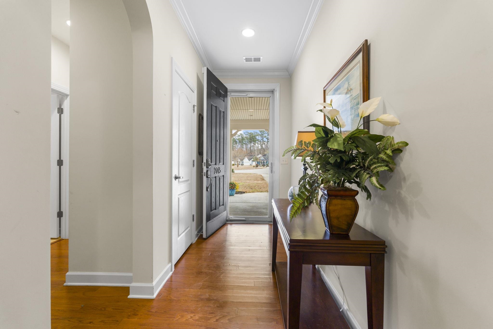 2015 Oxford Street Myrtle Beach, SC 29577 - Photo 33 of 40 Corridor featuring arched walkways, ornamental molding, dark wood-type flooring, and recessed lighting