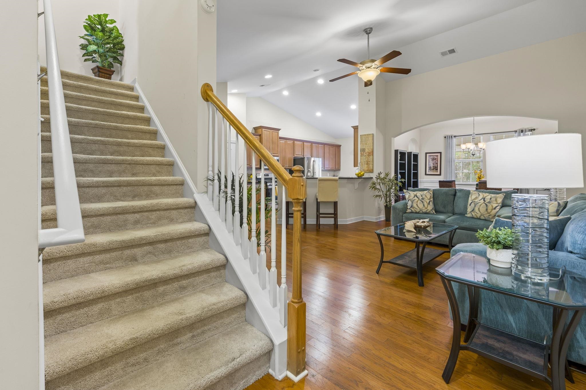 2015 Oxford Street Myrtle Beach, SC 29577 - Photo 5 of 40 Living room with recessed lighting, stairs, high vaulted ceiling, a chandelier, and wood-type flooring