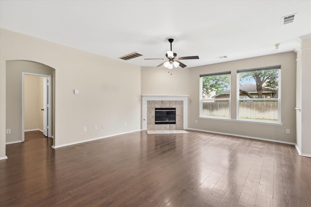 13236 Ridgepointe Road Fort Worth, TX 76244 - Photo 4 of 19 a view of an empty room with wooden floor and a window