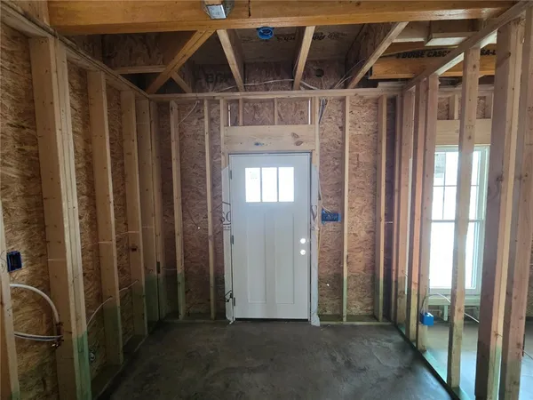 a view of a hallway with wooden walls