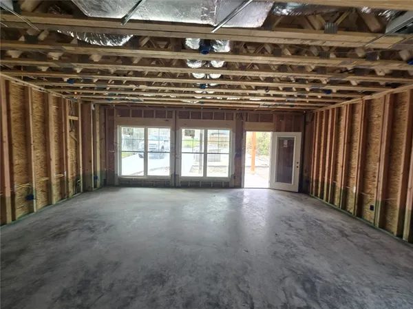 a view of an empty room with windows