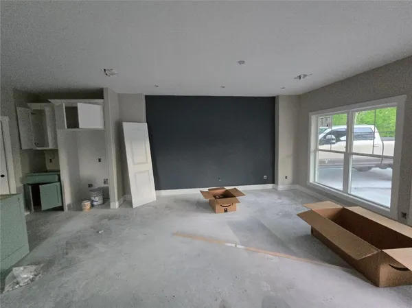 a large white kitchen with sink and refrigerator