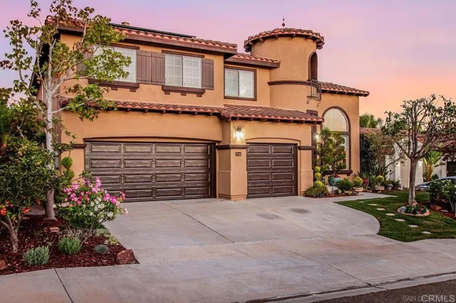 front view of a house with potted plants