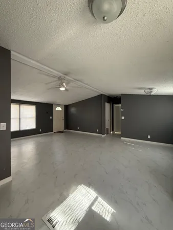a view of a livingroom with a ceiling fan and window