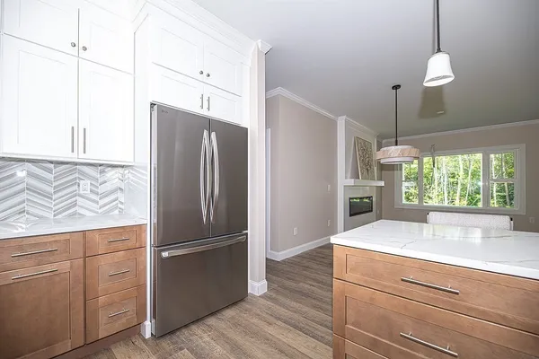 a kitchen with kitchen island a counter top space wooden floor and appliances