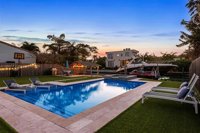 a view of swimming pool with seating area and furniture