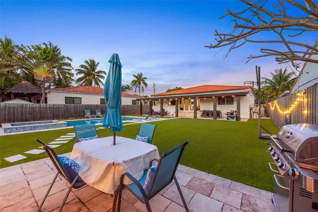 a view of a patio with a table and chairs