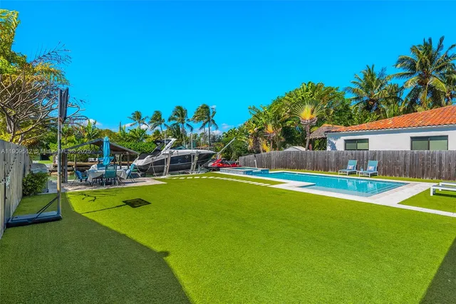 a view of a house with swimming pool and sitting area