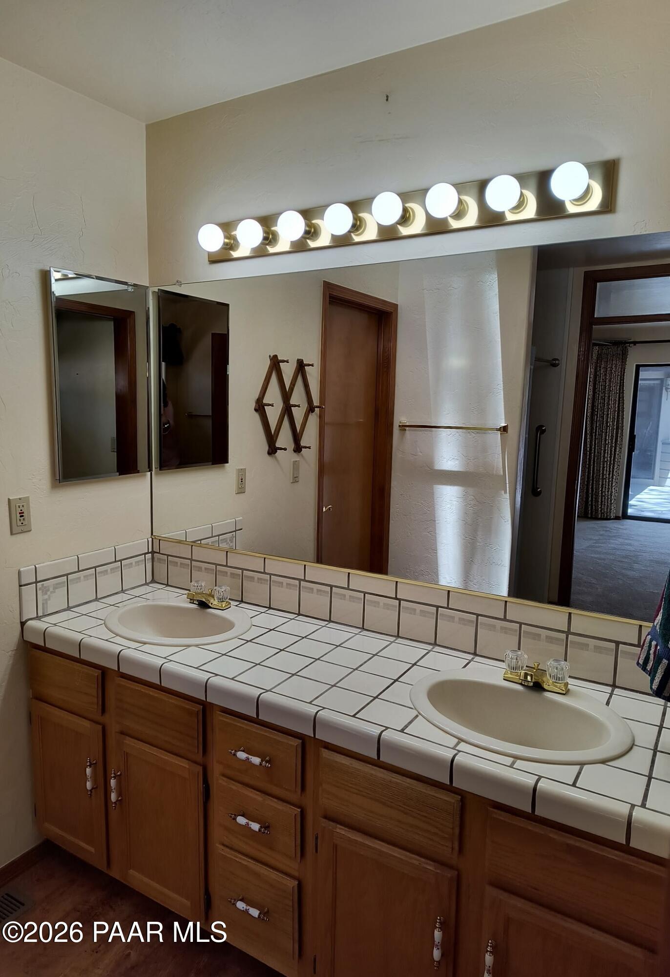 305 Ridge Court Prescott, AZ 86303 - Photo 13 of 35 a bathroom with a double vanity sink and a mirror
