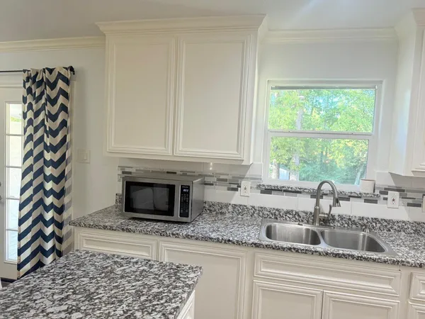 a kitchen with a sink and cabinets