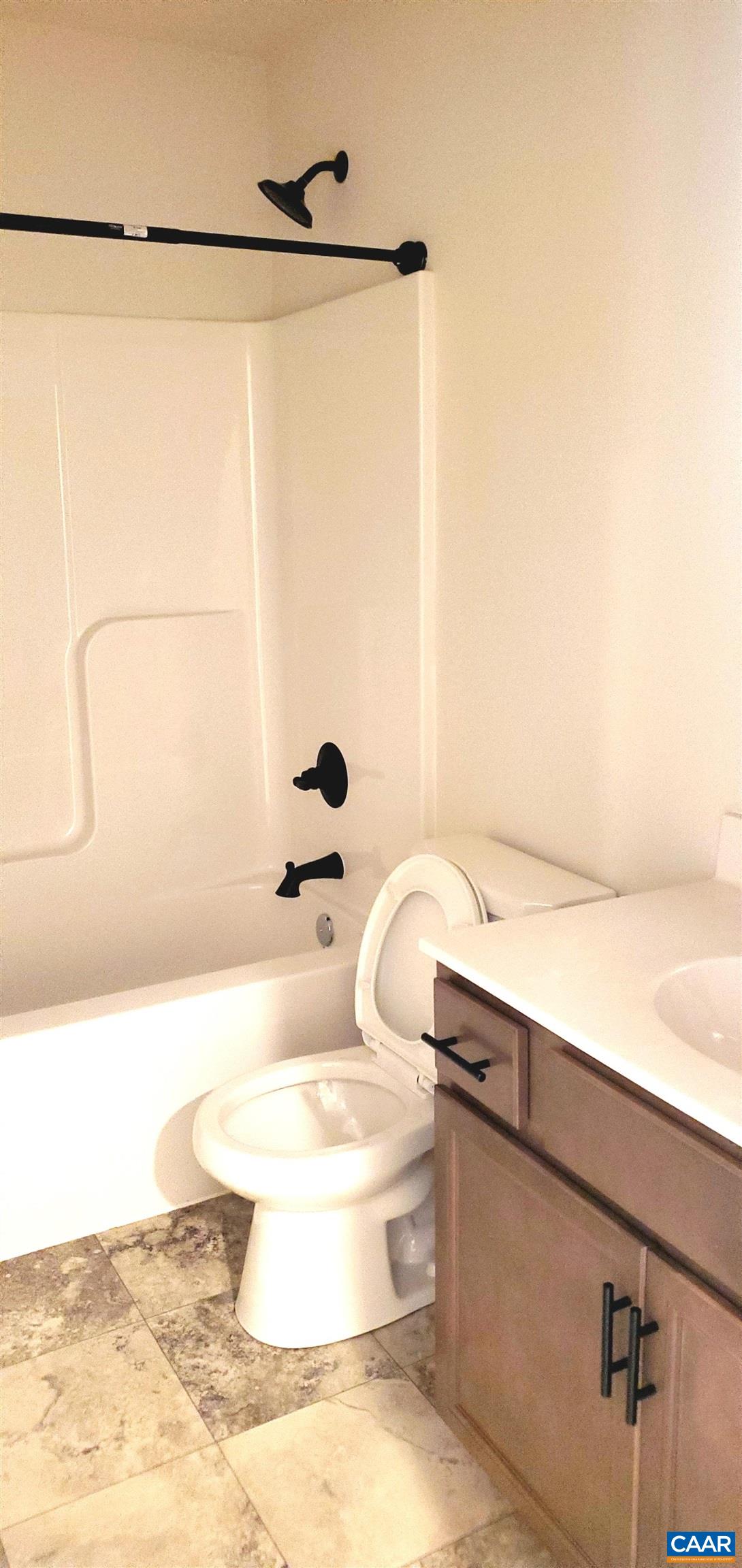 4245 Roundabout Road Louisa, VA 23093 - Photo 34 of 36 a bathroom with a sink and mirror with bathtub