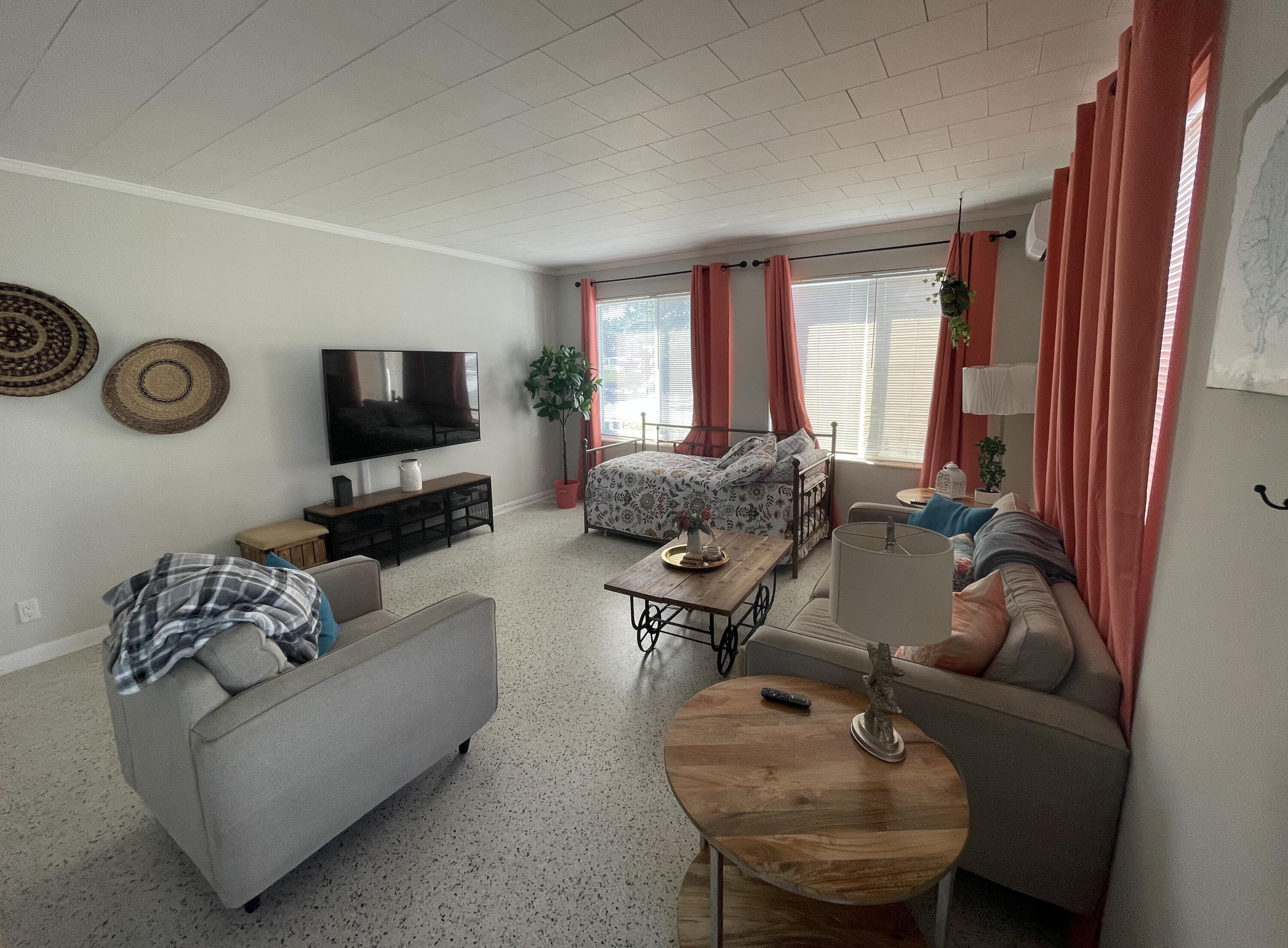 2023 South Suzanne Circle, Unit 1 North Palm Beach, FL 33408 - Photo 2 of 10 a living room with furniture and a flat screen tv