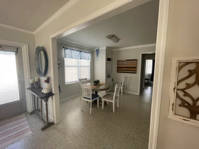 a dining room with furniture and entryway