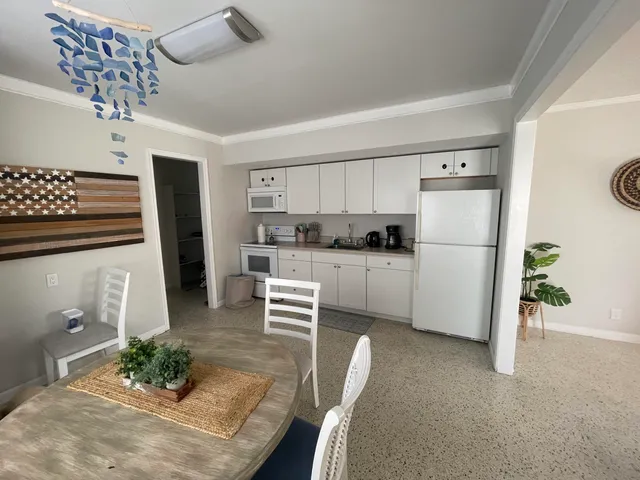 a kitchen with stainless steel appliances granite countertop a refrigerator sink and stove