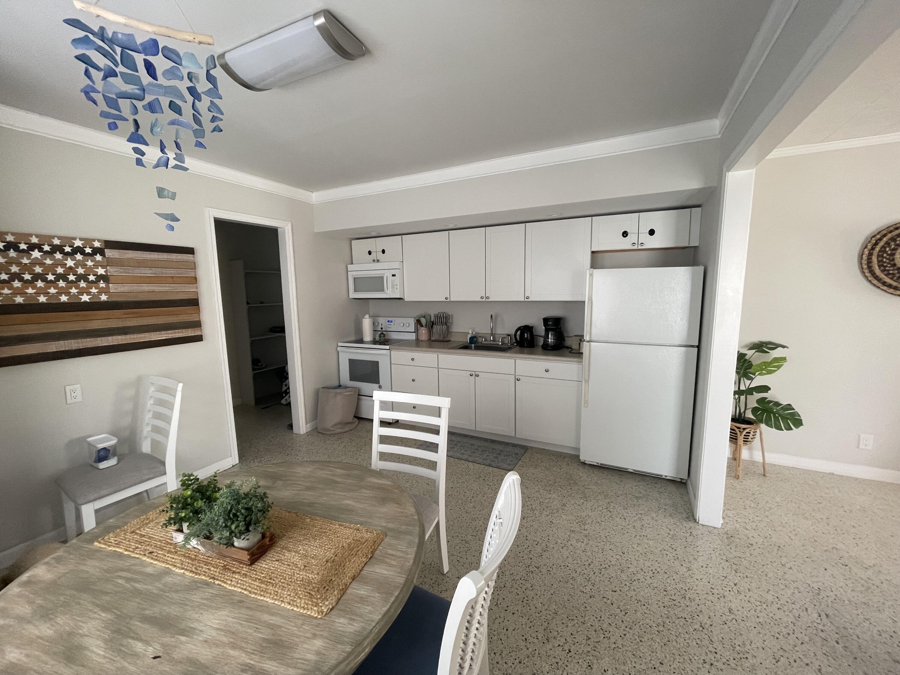 2023 South Suzanne Circle, Unit 1 North Palm Beach, FL 33408 - Photo 6 of 10 a kitchen with stainless steel appliances granite countertop a refrigerator sink and stove