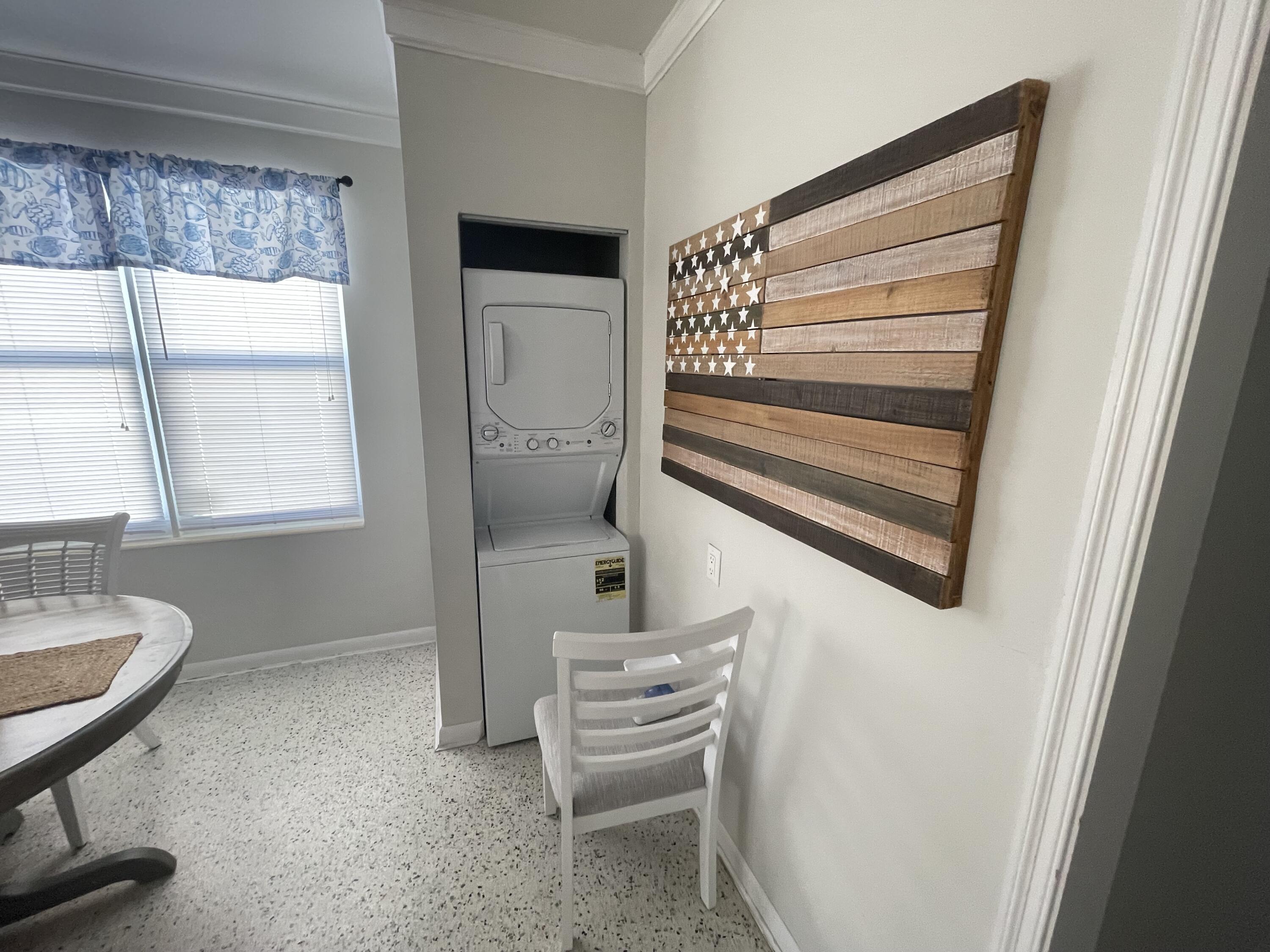 2023 South Suzanne Circle, Unit 1 North Palm Beach, FL 33408 - Photo 7 of 10 a bedroom with a bed and a window