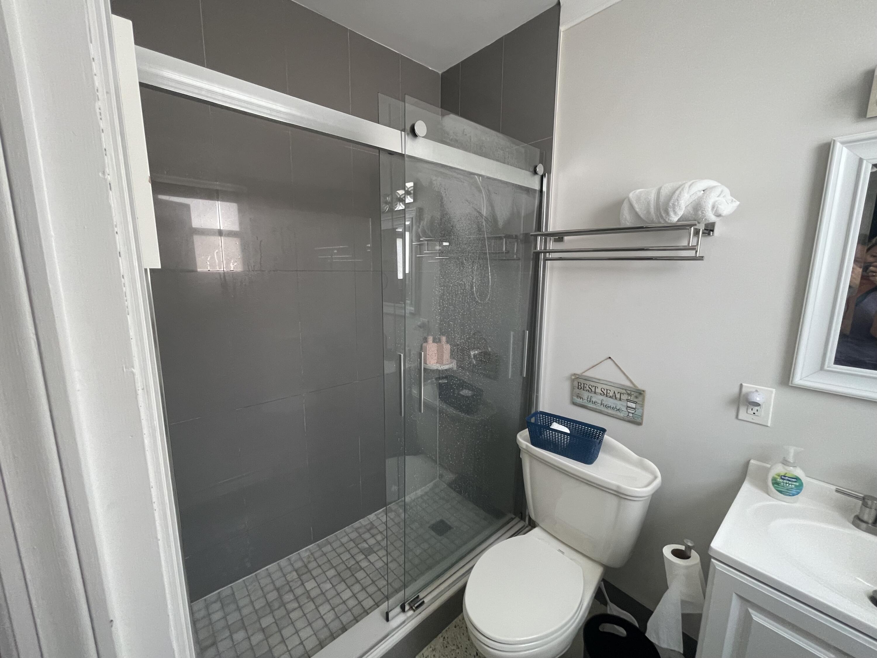 2023 South Suzanne Circle, Unit 1 North Palm Beach, FL 33408 - Photo 9 of 10 a white toilet sitting next to a bathroom sink and vanity