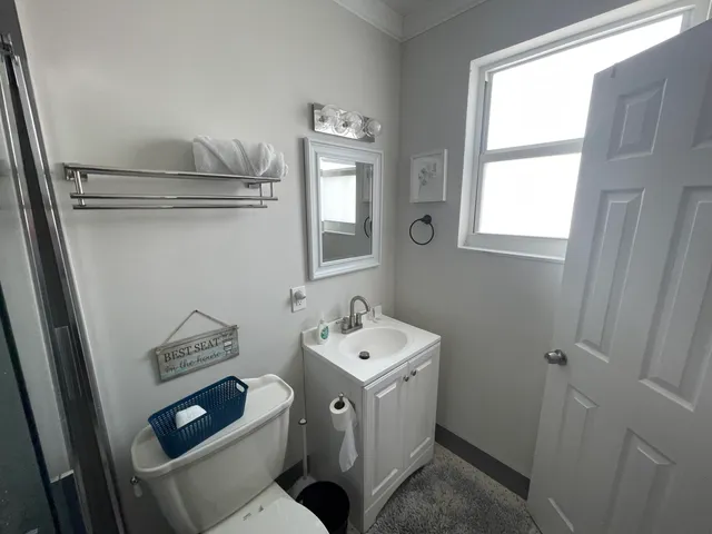 a bathroom with a toilet sink and mirror