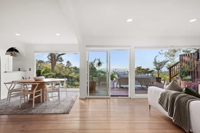 a living room with furniture a rug and a large window