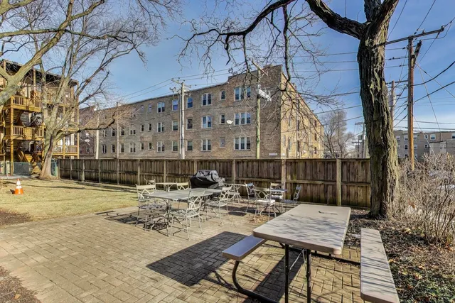 a view of a patio with iron fence
