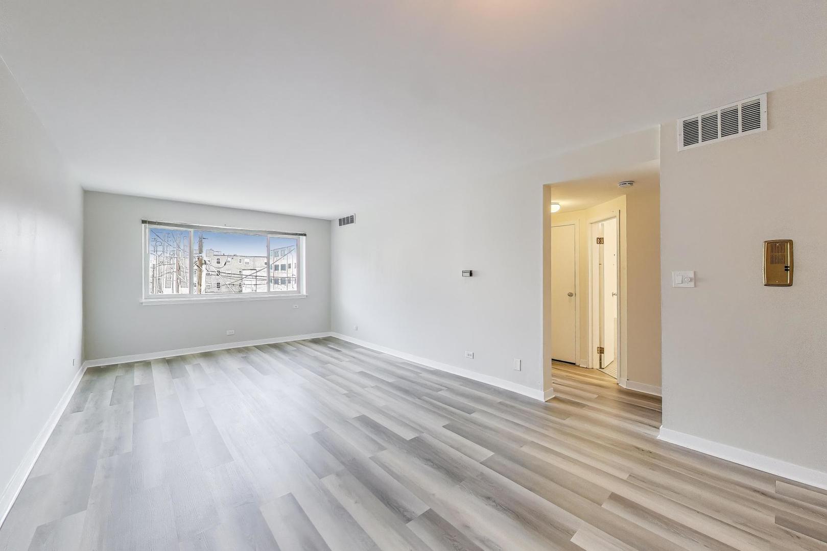 835 Ridge Avenue, Unit 205 Evanston, IL 60202 - Photo 3 of 18 a view of an empty room and wooden floor