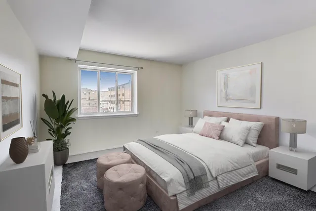 a bedroom with a bed and a potted plant