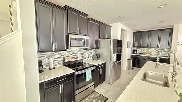 a kitchen with a sink stove and refrigerator