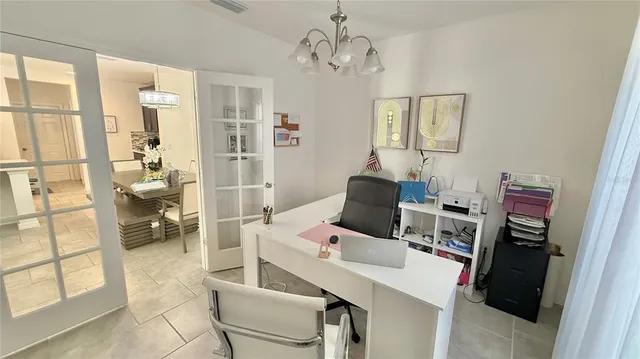 a view of a workspace with furniture and a window