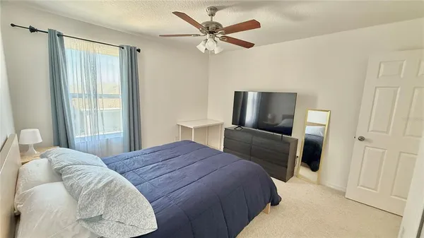 a bedroom with a bed and a television