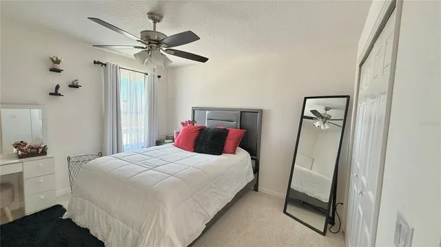 a bedroom with a bed and a mirror