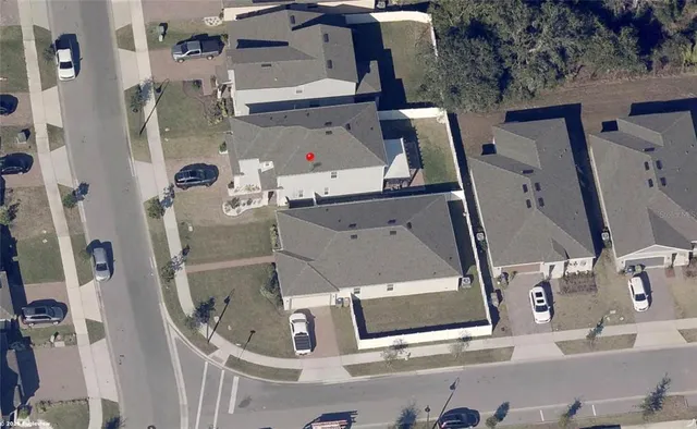 an aerial view of residential houses with outdoor space