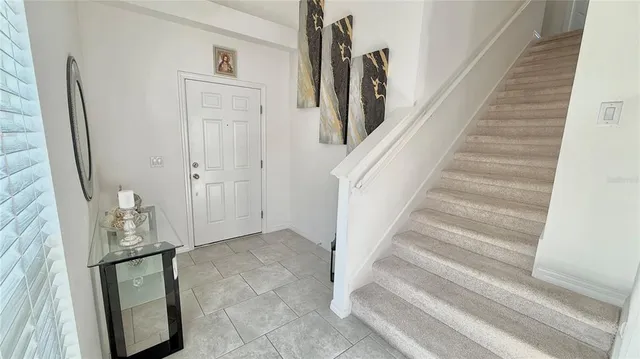 a view of staircase with white walls and railing