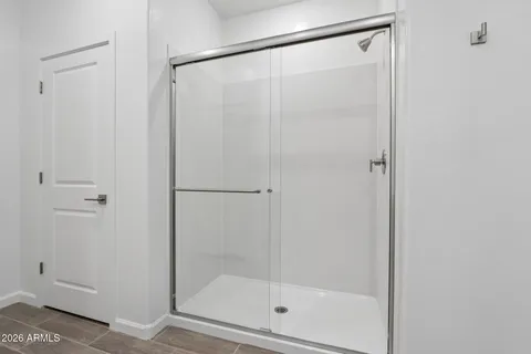 a bathroom with a glass shower door