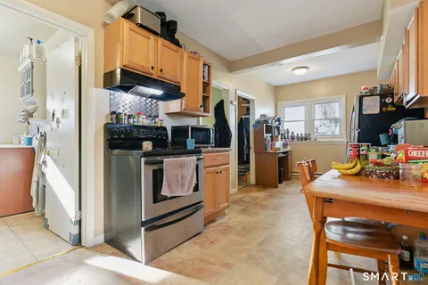 a kitchen with stainless steel appliances a stove a refrigerator and a refrigerator