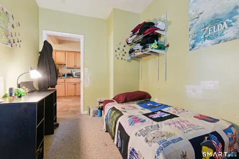 a bedroom with a bed and a chandelier