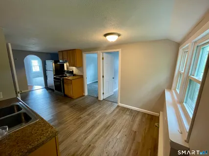 a view of a hallway with wooden floor and staircase