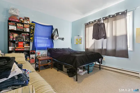 a spacious bedroom with a bed and a window