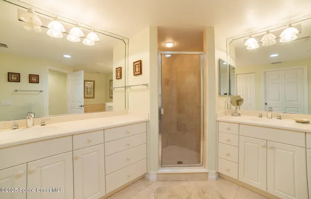 a bathroom with a shower sink double and mirror