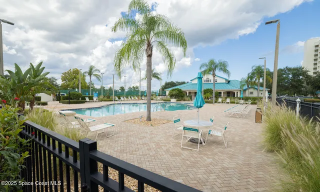 a view of swimming pool with outdoor seating and plants