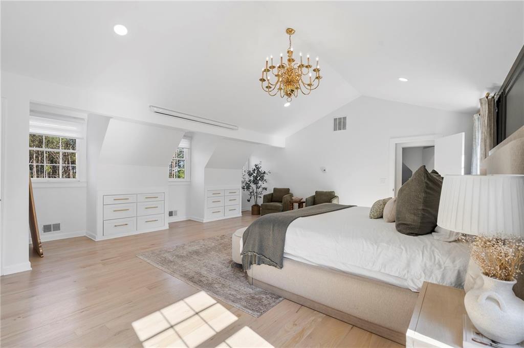 403 Rockbridge Road Southwest Lilburn, GA 30047 - Photo 39 of 77 a bedroom with a bed and a chandelier