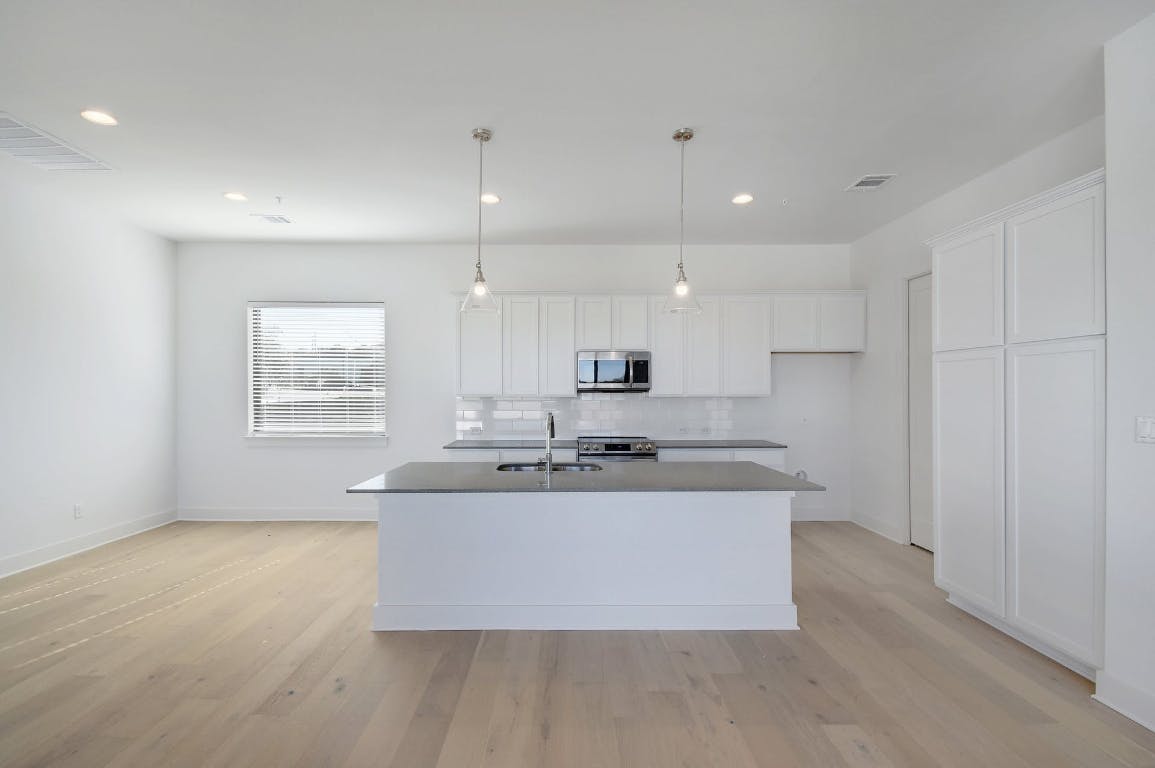 2050 Lohmans Spur Road, Unit 402 Austin, TX 78734 - Photo 11 of 39 a large kitchen with a large window