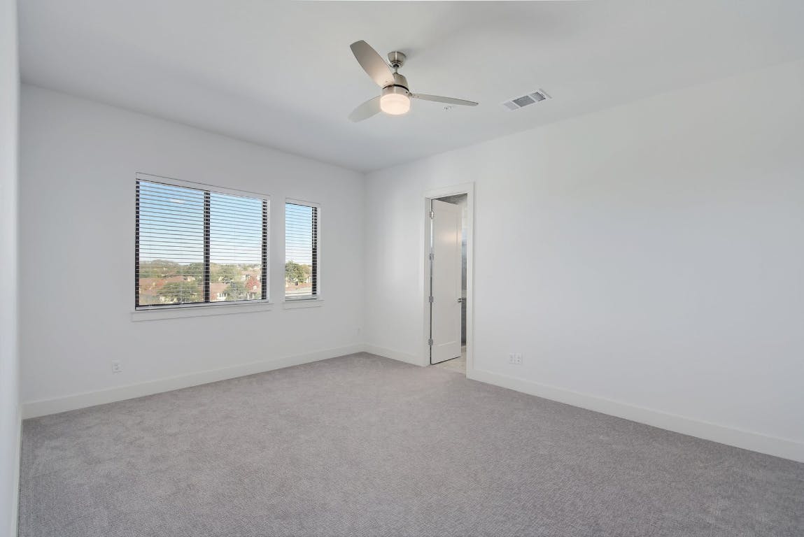 2050 Lohmans Spur Road, Unit 402 Austin, TX 78734 - Photo 18 of 39 an empty room with a window and a ceiling fan